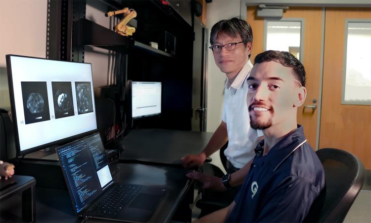 Professor Jun Ueda and robotics Ph.D. student Heriberto Nieves at a computer terminal with liver scans on the screen.