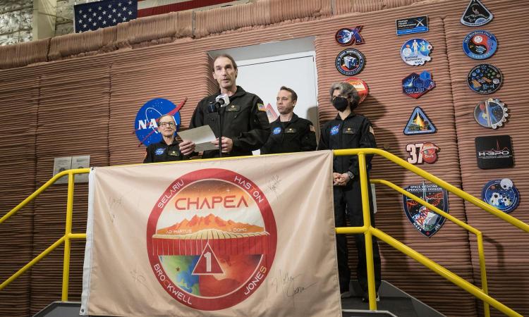 Ross Brockwell speaks with his three colleagues looking on outside the simulated Mars habitat after the team emerged from a year-long stay inside.
