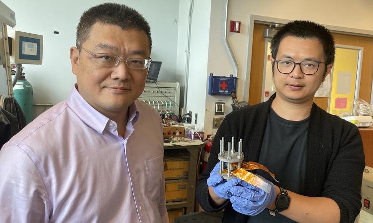Hailong Chen and Zhantao Liu, who's holding a new, low-cost cathode for all-solid-state lithium-ion batteries.