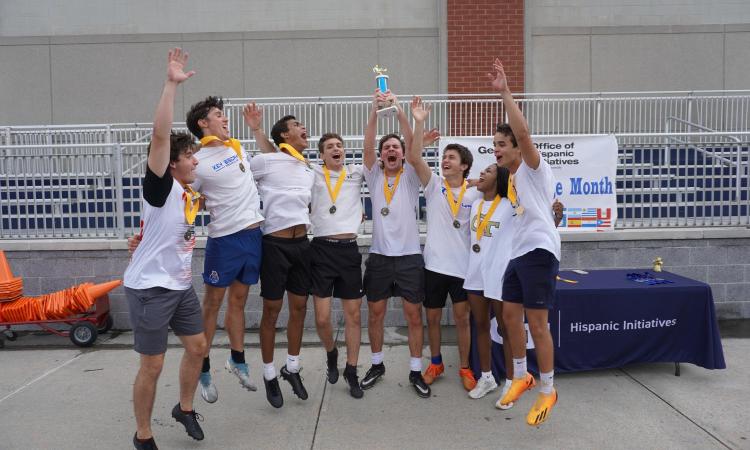 students celebrating with trophy