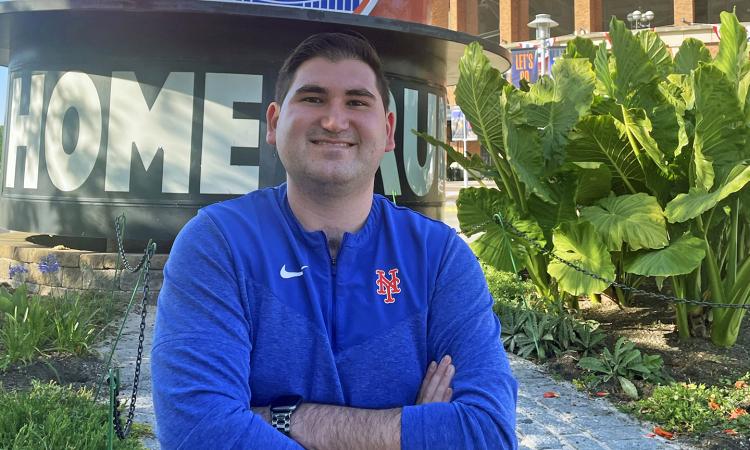 Dylan Pané stands with arms crossed outside Citi Field.