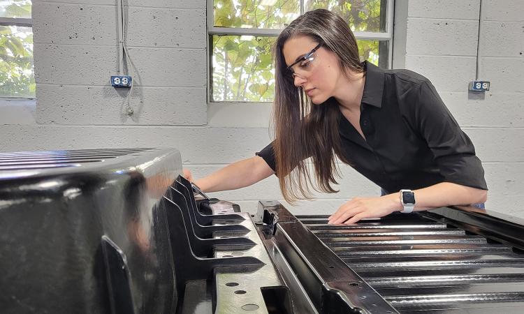 Amanda Nummy looks at a truck bed liner in the lab