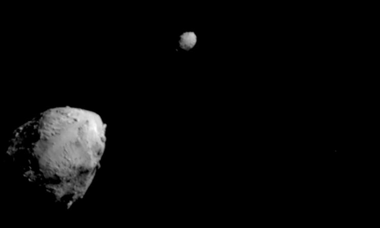 One of the DART mission’s final images of asteroid Dimorphos prior to impact. The image shows one large asteroid, Didymos, in the lower left and the smaller Dimorphios in the middle against the blackness of space. (Photo: NASA/Johns Hopkins APL)