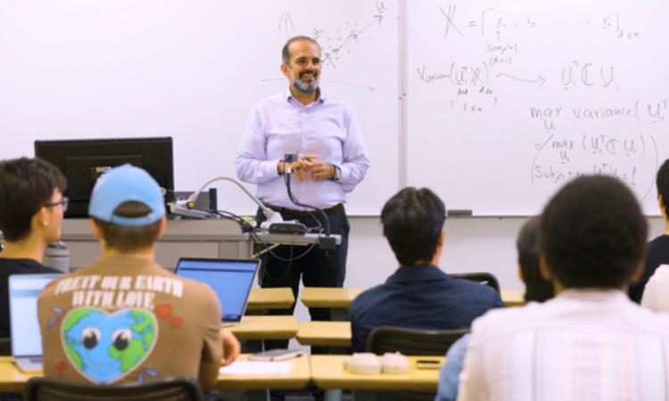 Ghassan AlRegib stands in front of a classroom of students during his AI Foundations course.