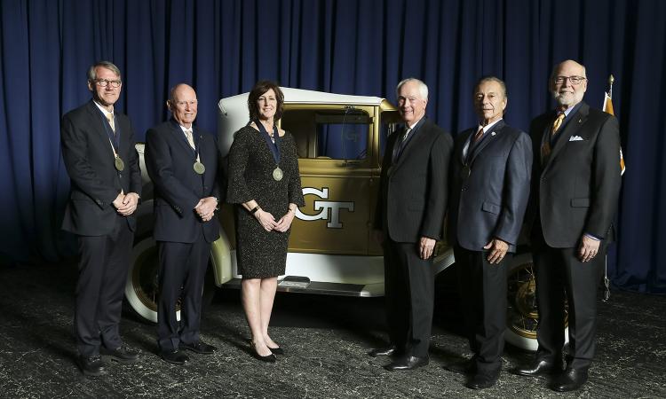 Six new Hall of Fame inductees pose with their medals and the Ramblin' Wreck.