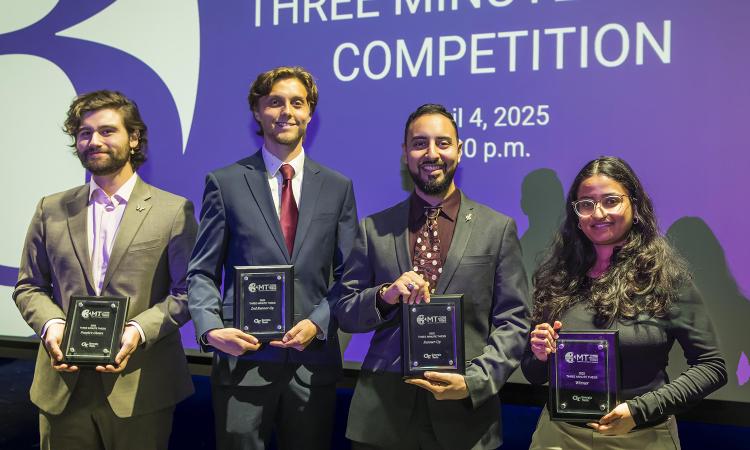 Four student winners pose with plaques.