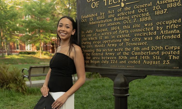 Gianna Fiduccia poses by the Georgia Tech historical marker near Tech Tower.