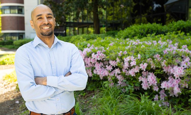 Anirban Mazumdar photographed in front of a research building.