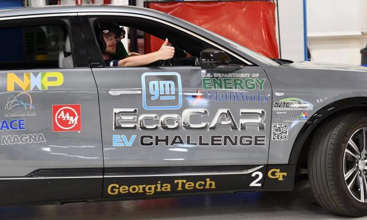 Project manager Eric Gustafson gives a thumbs up out of the passenger window of the Georgia Tech EcoCAR after high speed on-road safety tests.