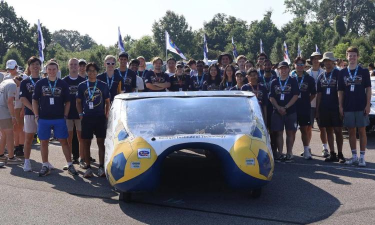 Members of the Solar Racing team with their custom-built car, the SR-4: Aurora