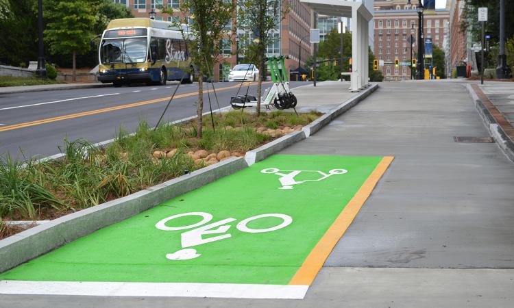 Part of the new protected cycle track on Georgia Tech's campus, which provides travel lanes for bikes, scooters, and skateboards that is separated from vehicle and pedestrian traffic.