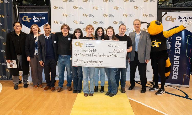 group of people with oversized check and mascot buzz
