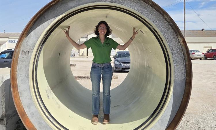Antonia Kopp stands inside a pipe during a site visit.