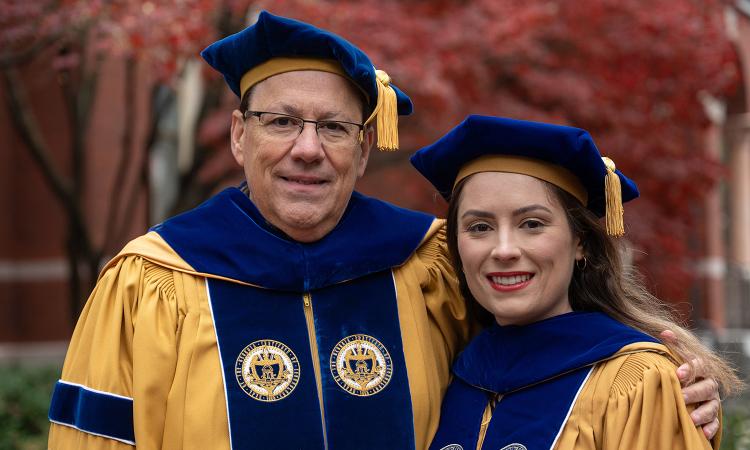 Dimitri and Sophia Mavris pose in their Ph.D. regalia.