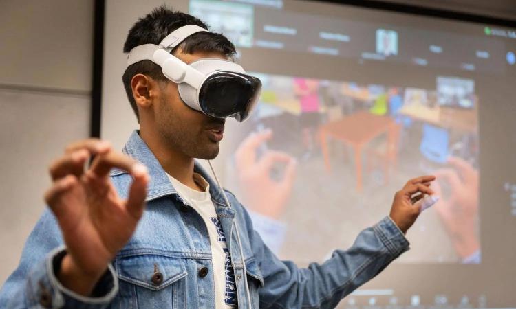 Georgia Tech student Yash Rajgure uses an Apple Vision Pro headset to demo a team project in an entrepreneurship course.