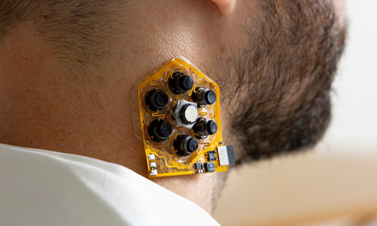 a patch of haptic actuators shown on a user's neck
