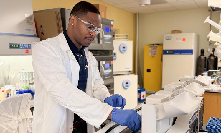 Kendreze Holland works with samples in the lab.