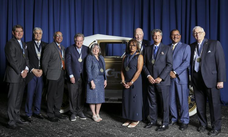 Newly inducted Engineering Hall of Fame members pose with the Ramblin' Wreck.