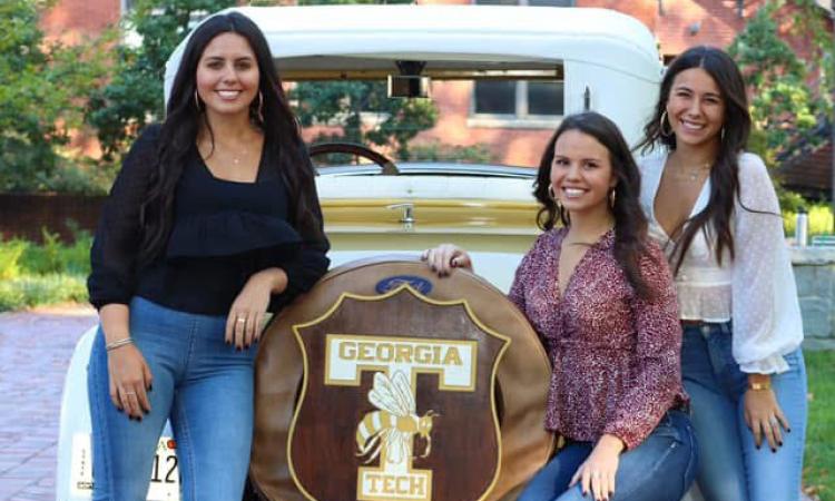 Shelley, Allison, and Isabella Larson pose with the Ramblin' Wreck.