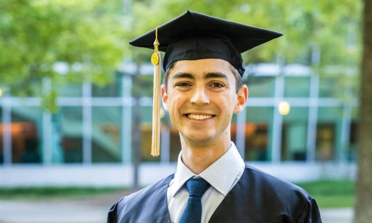 Michael Silas poses in his cap and gown.