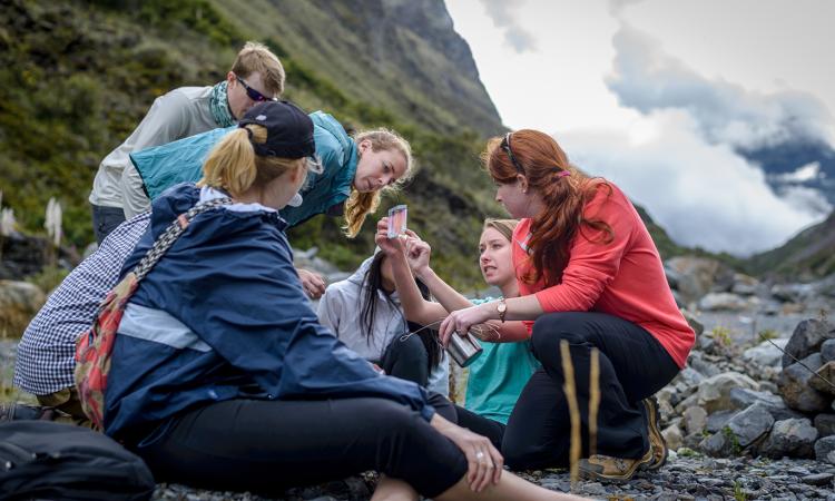 Students examine a water sample in the mountains of Bolivia.