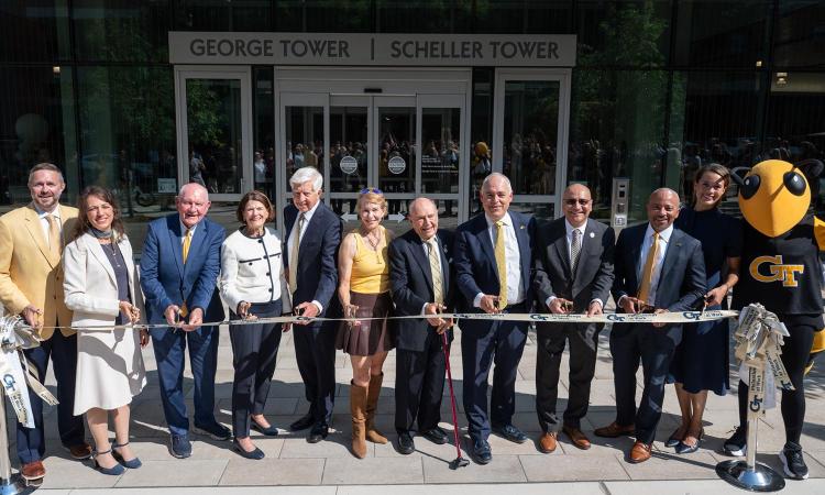 Dignitaries cut the ribbon outside the new George Tower and Scheller Tower.