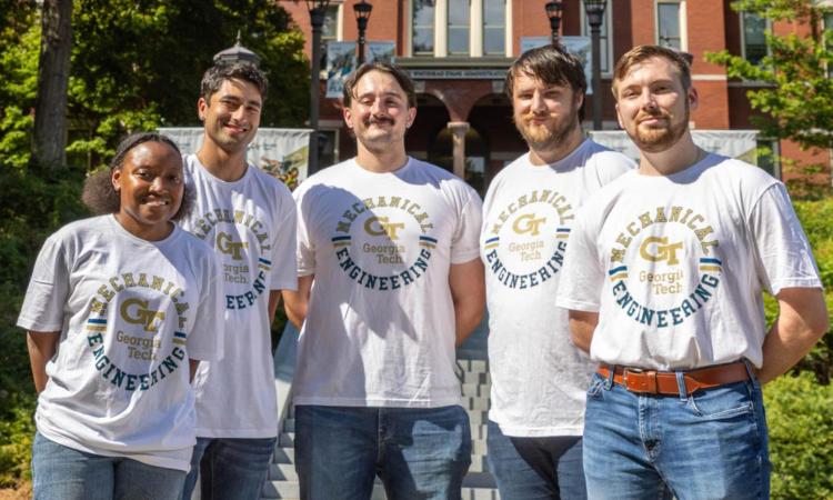 Five members of the drone racing team pose in front of Tech Tower.
