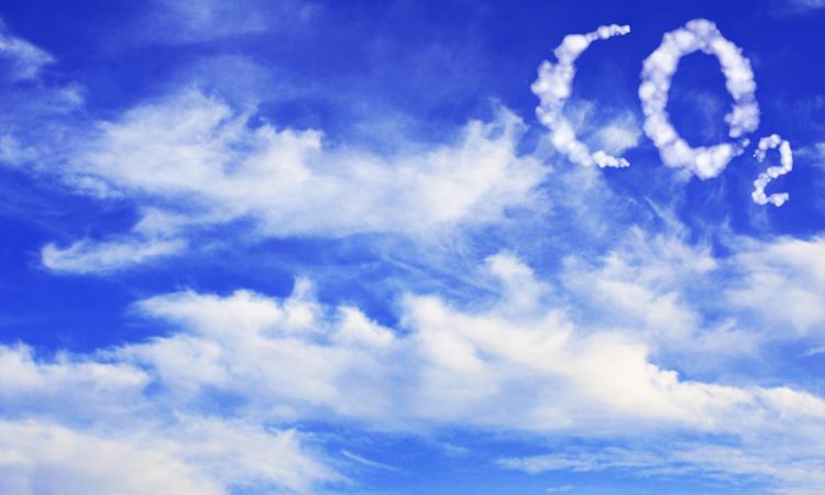 Illustration of puffy clouds in a blue sky spelling out the characters CO2.