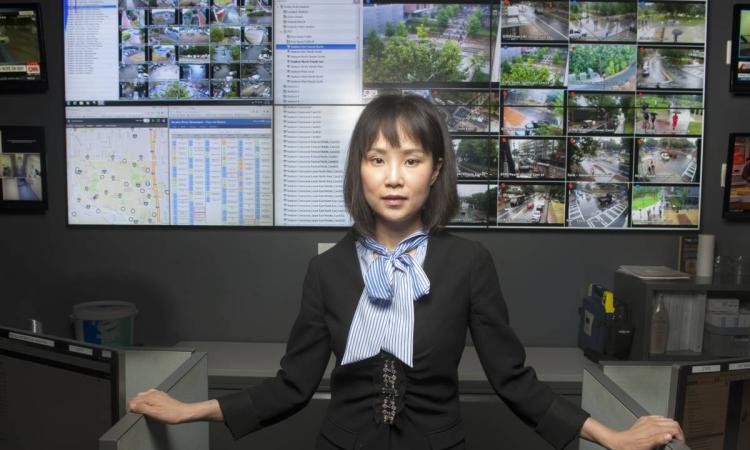 Yao Xie in front of computer screens