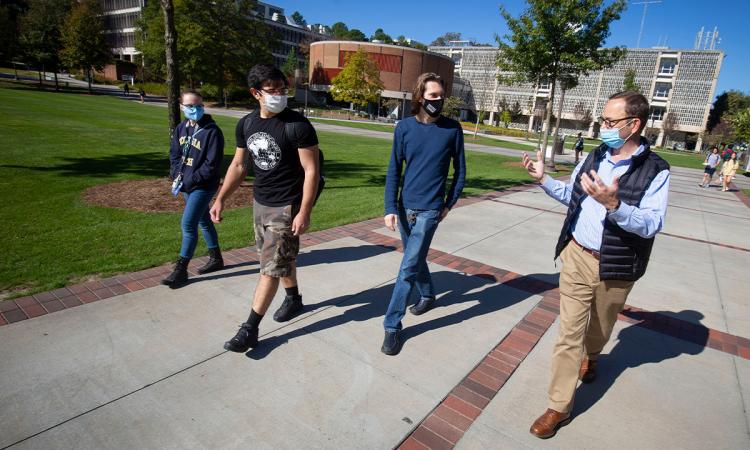 3 students and professor in masks outside (photo)