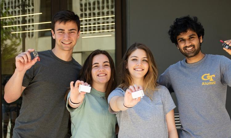 The StrideLink team members display the device and hardware components