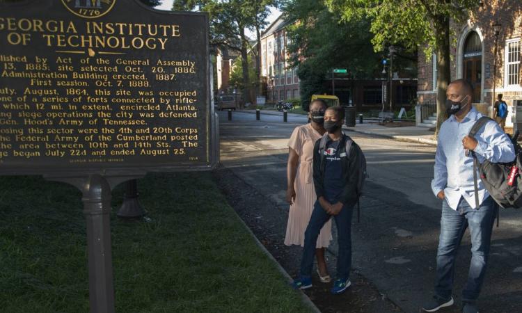 Caleb and his family on campus