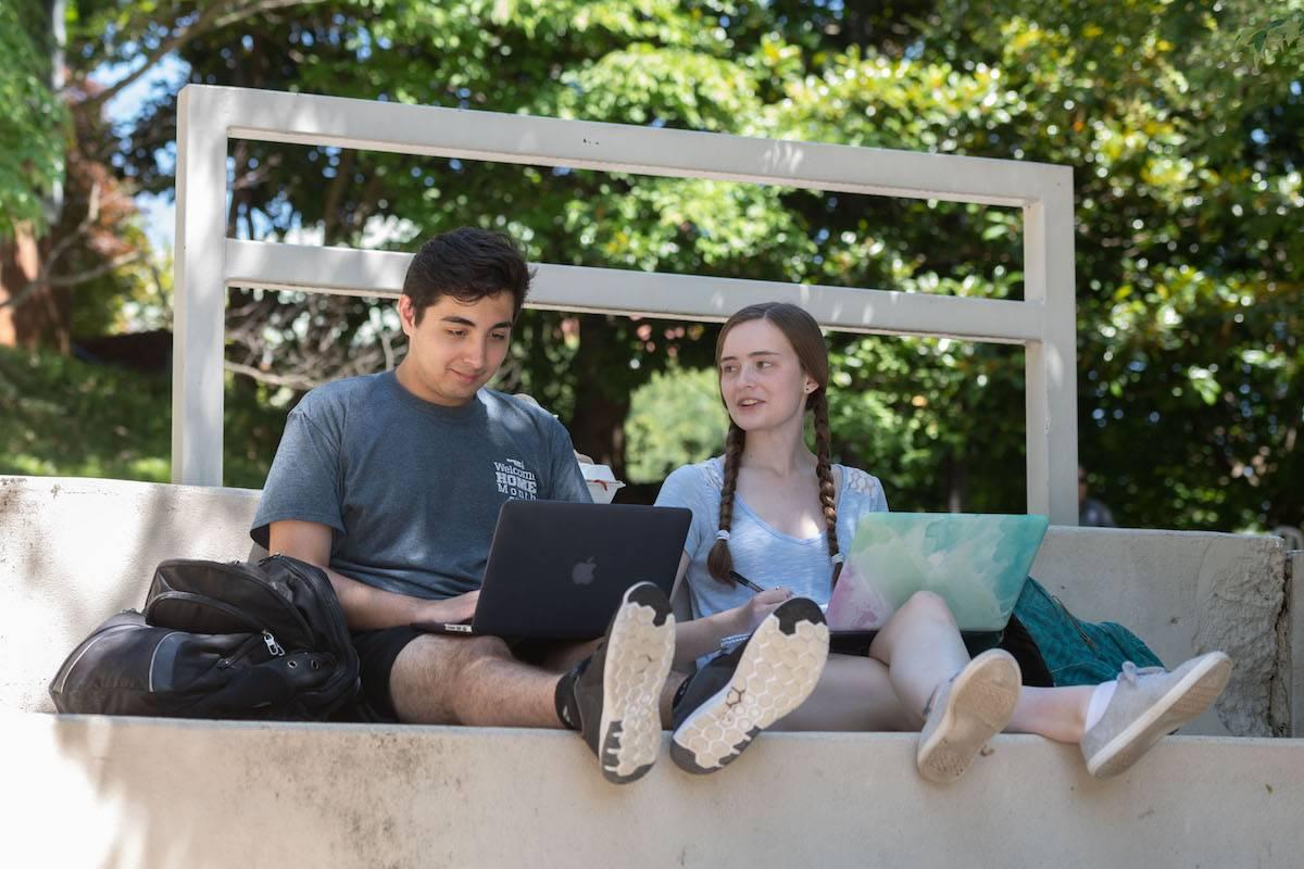 Students working on school work outside.