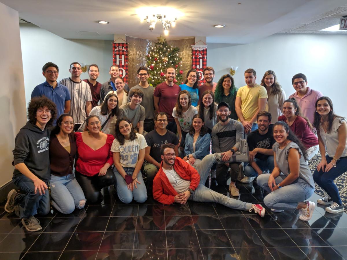 group of LOGRAS students in front of Christmas tree