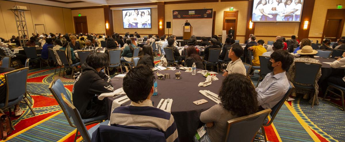 A ballroom of Metro Atlanta high school students at tables listening to Georgia Tech's Felicia Benton-Johnson. (Photo: Candler Hobbs)