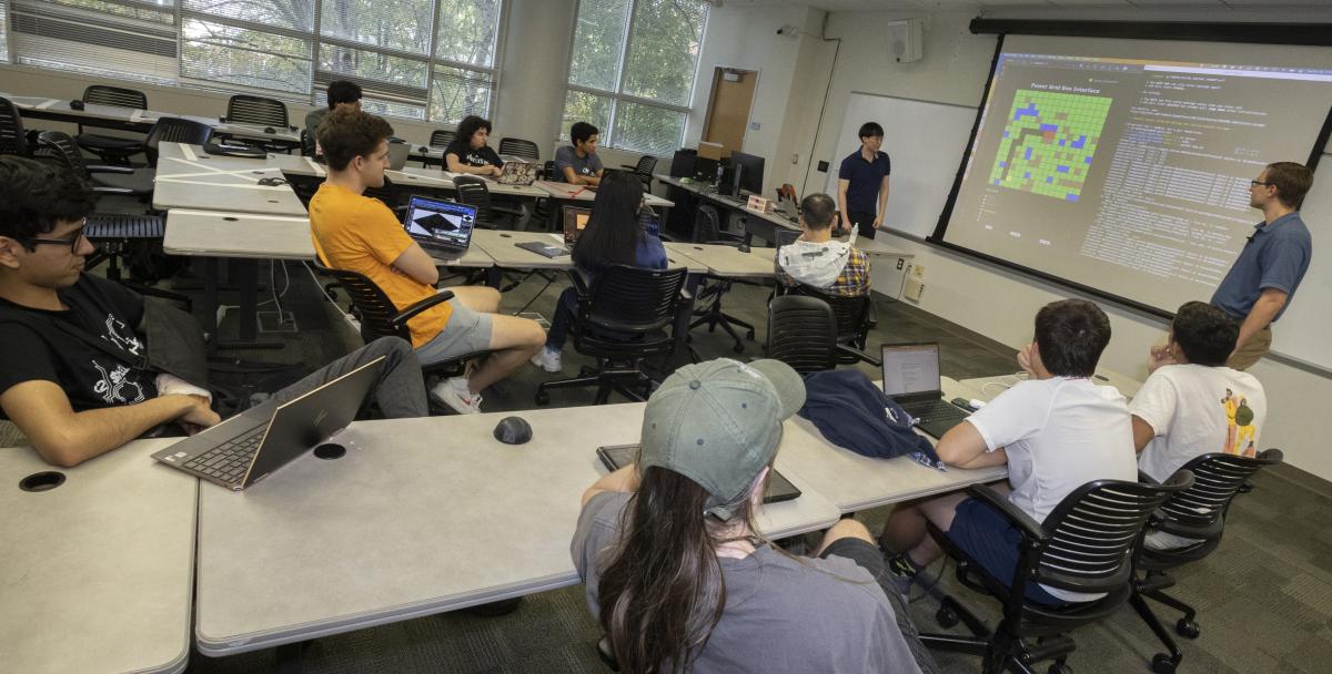 VIP students in a classroom with laptops looking at a screen