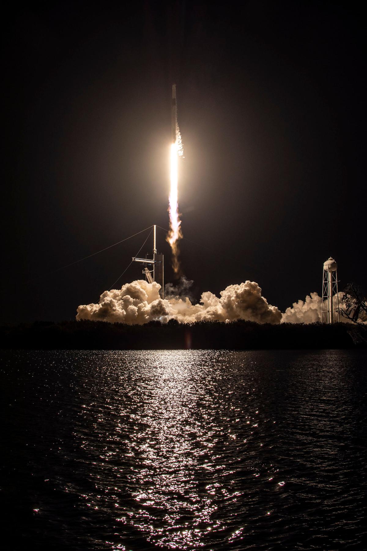 Falcon-9 rocket lifting off at night