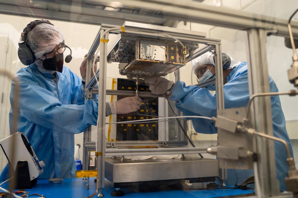 Two people working with Lunar Flashlight in a clean room