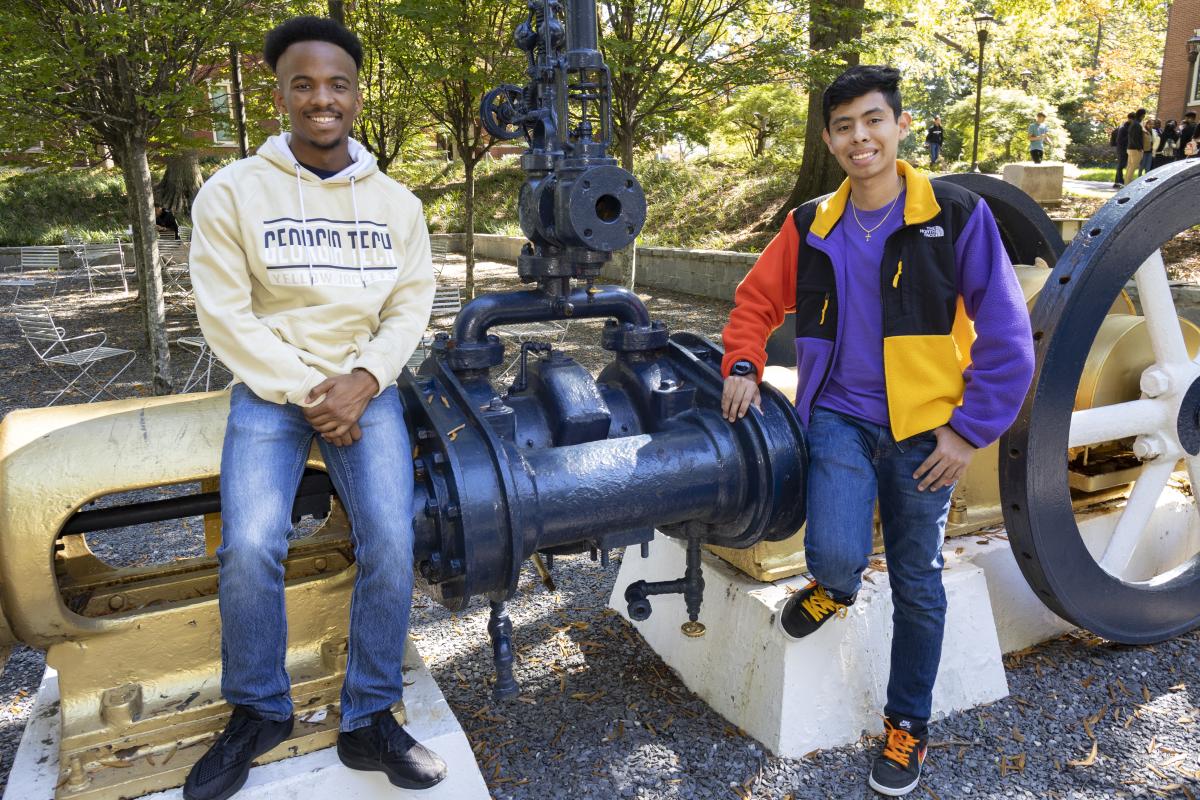 Two students with the steam engine at Georgia Tech