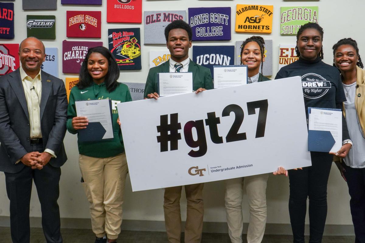 Raheem Beyah with 4 Drew Charter School students and staff member from GT admissions, holding #gt27 sign