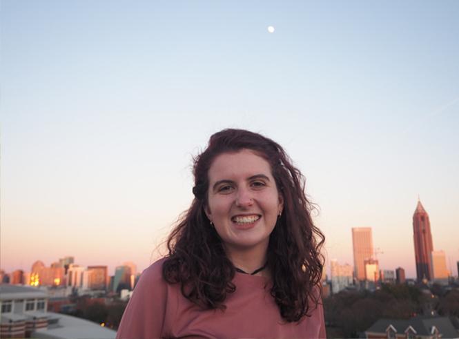 Simrill Smith in front of the Atlanta skyline at dusk