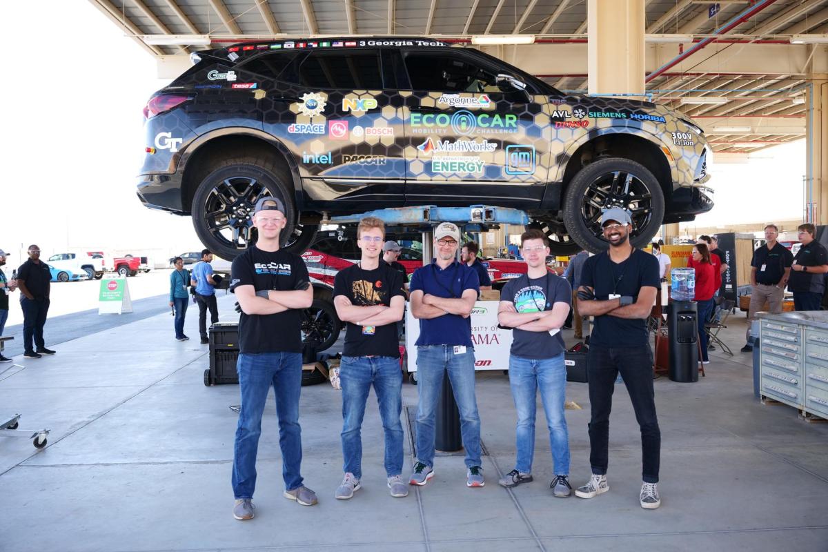 Team members with the car