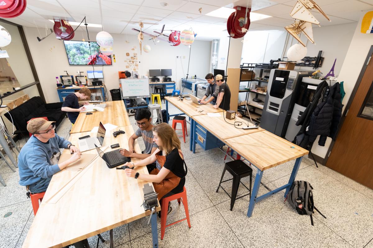 A wide shot of the Aero Maker Space with students working at tables