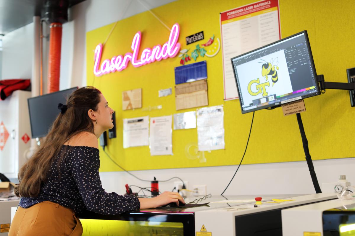 A student sets up a design on a computer to use with the laser cutter in the Invention Studio.