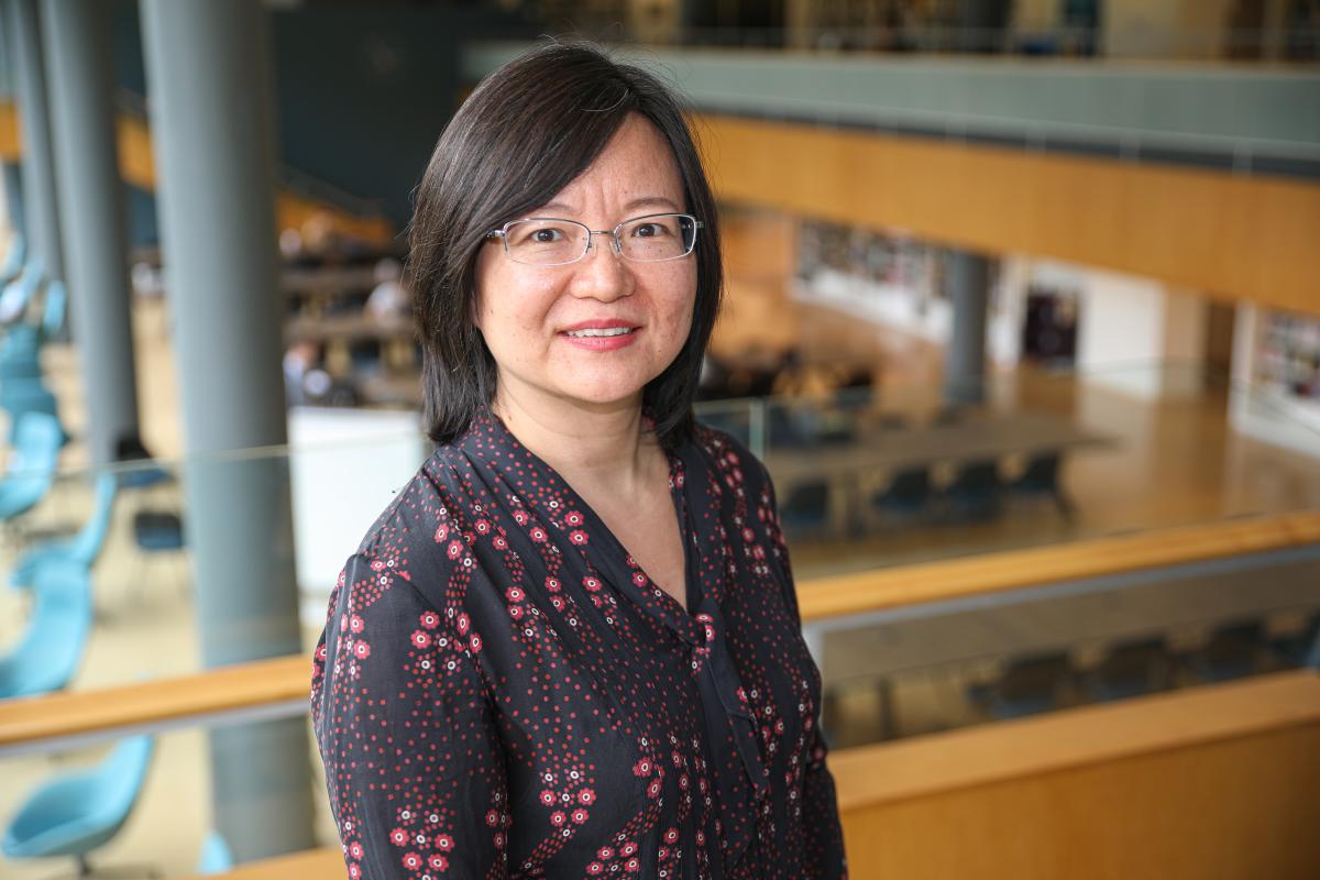 Ying Zhang overlooking the library from the second floor