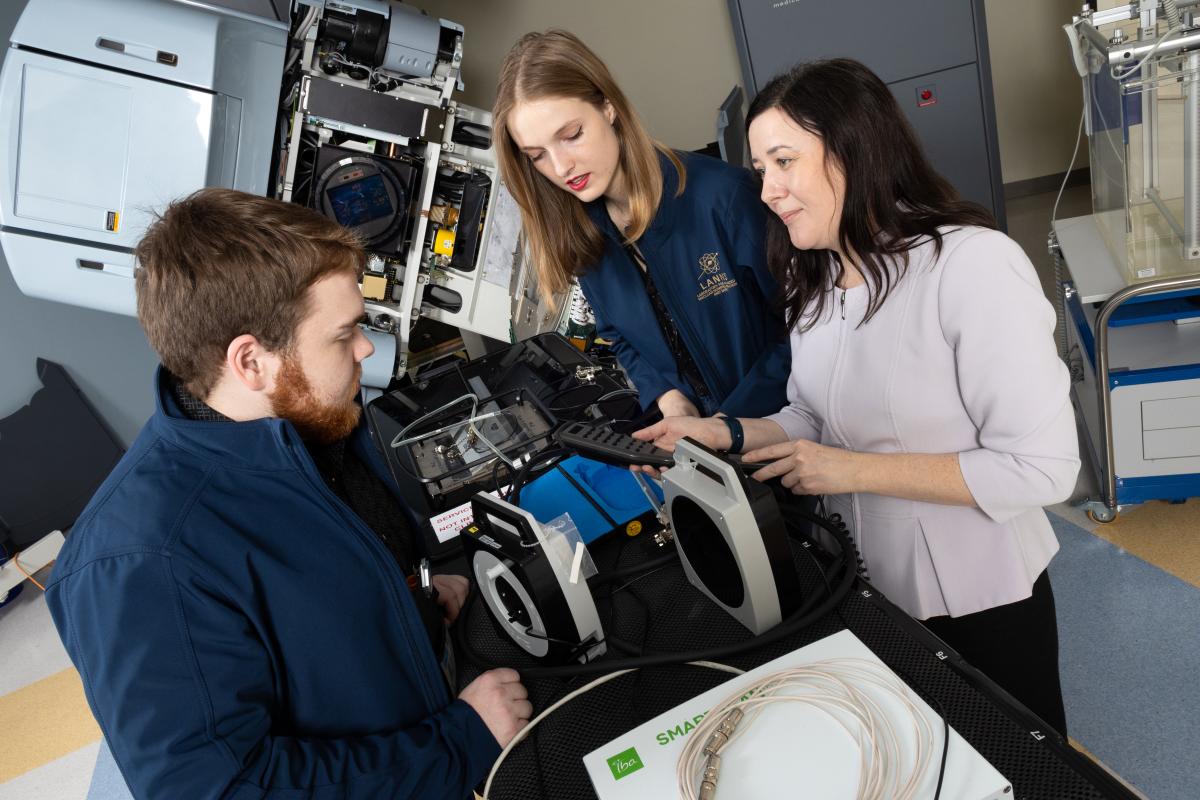 Anna Erickson and two students work in the lab