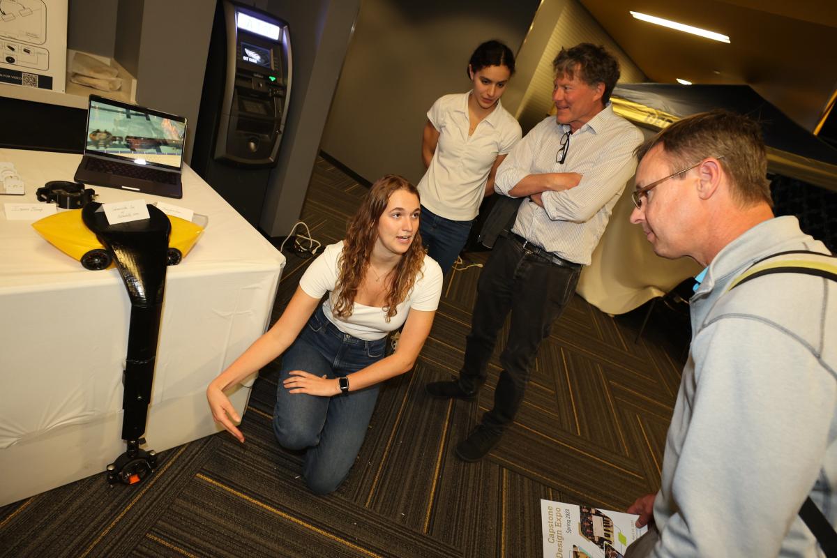 people looking at a camera device on a table