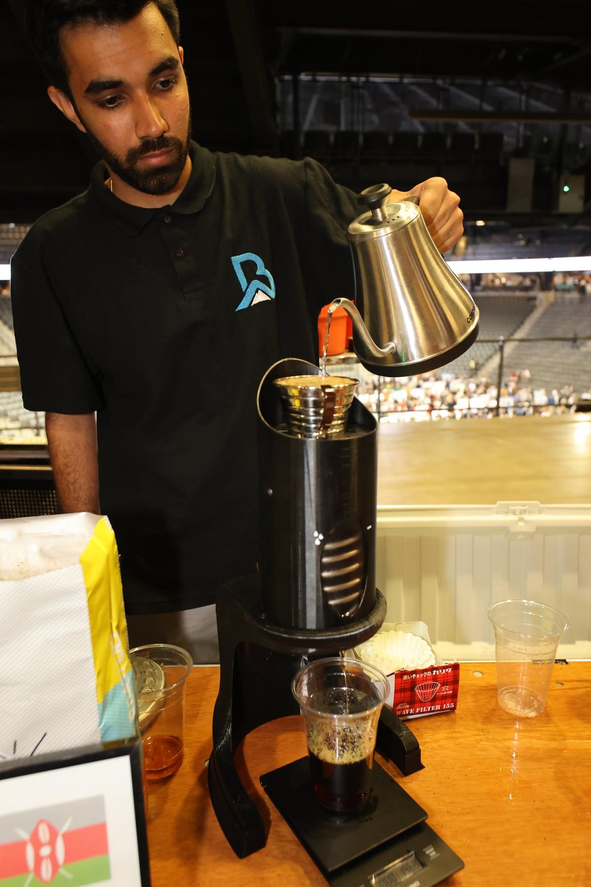 man pouring liquid into a device