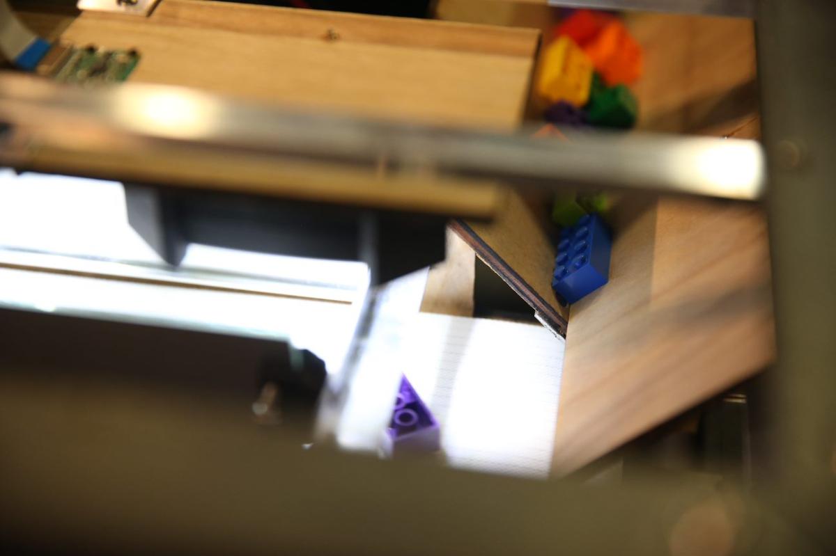 a closeup view of Lego bricks in a sorting device