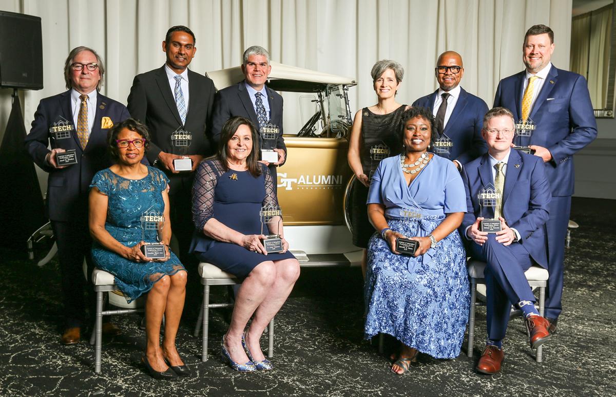 The group of Distinguished Engineering alumni Inductees gathered around the Ramblin' Wreck